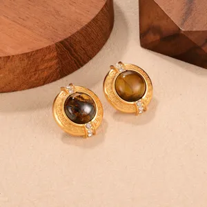 Detailed view of vintage gold tiger eye earrings with Greek key pattern and crystals