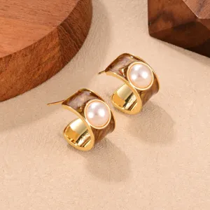 Detailed close-up of vintage Maillard C-shape earrings with tiger-eye pattern and pearl inlay