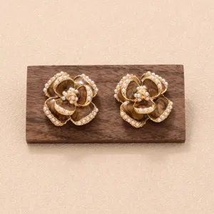 Vue détaillée de boucles d'oreilles vintage en forme de fleur avec résine marron et perles