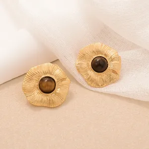 Detailed view of vintage gold sunflower earrings with tiger eye stone centers