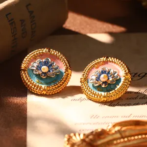 Detailed view of French court style enamel earrings with natural pearl and gold trim