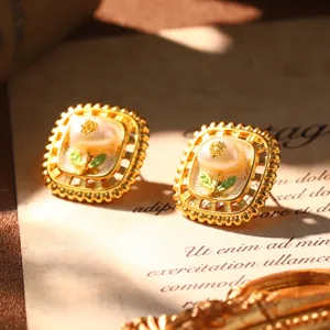 Close-up detail of French vintage style enamel gold earrings with natural white pearl