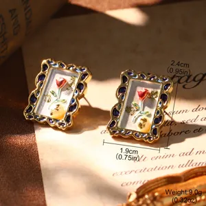 Detailed macro view of vintage French style earrings with red rose oil painting motif