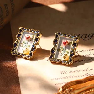Detail of French vintage Monet oil painting earrings with pearl and enamel rose pattern.