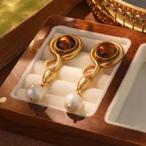 Detailed view of vintage French court style earrings with tiger eye and pearl drops