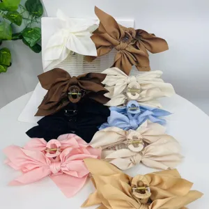 Large fabric bow hair claw clips for women in various colors for elegant hairstyling.