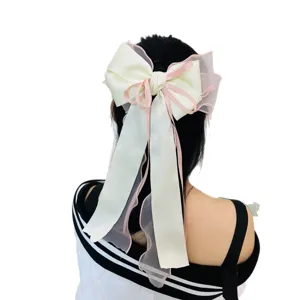 Elegant large ribbon bow hair clip in cream and pink for princess hairstyles.