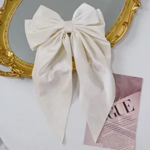 Detail view of the soft white velvet texture on this vintage-style large bow hair clip.