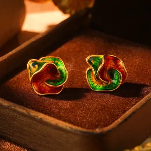 Close-up view of vintage rainbow enamel stud earrings featuring a 3D oil painting style