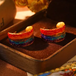 Macro view of artistic oil painting series rainbow enamel hoop earrings with textured finish