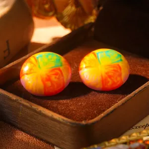 Detailed view of vintage oil painting style rainbow enamel stud earrings in box