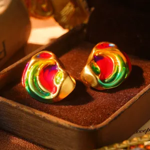 Detailed view of vintage rainbow enamel gold-plated stud earrings with vivid colors