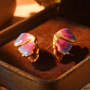 Detailed macro view of vintage oil painting style rainbow enamel earrings in a luxury box