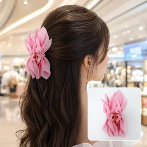 Pink fabric butterfly bow hair claw clip shown on long wavy hair with a close-up inset view