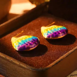 Close-up of rainbow enamel vintage stud earrings in a wooden jewelry box