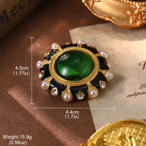 Macro view of vintage green gem brooch with pearls and rhinestones decoration.
