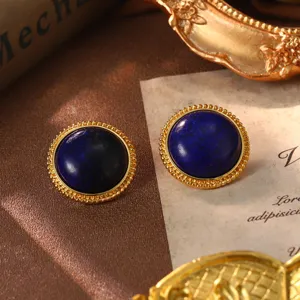 Detailed close-up of vintage round earrings featuring dark blue stones and golden rope edges