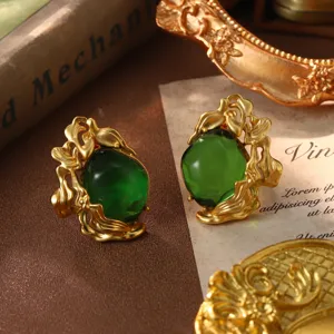 Exquisite macro detail of vintage gold floral earrings with translucent emerald green stones