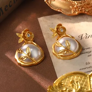 Detailed close-up of vintage gold rose earrings with large white pearls and crystal accents