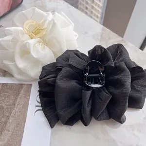 Detailed view showing the texture of elegant bubble bow hair claw clips in black and white