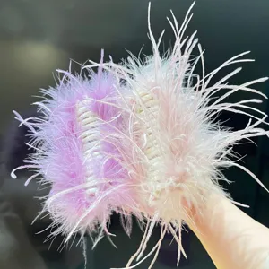 Detailed close-up of fluffy ostrich feather hair claw clips in pink and purple tones