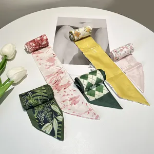 Variety of vintage French style patterned silk hair ribbons arranged on a table.