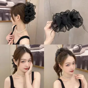 Detailed view of an elegant black feather mesh cloud hair claw clip worn by a model