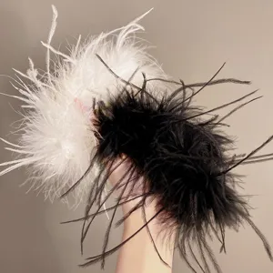Close-up of elegant black and white ostrich feather hair claws for women's hair styling.