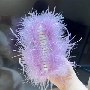Close-up view of a lavender ostrich feather hair claw clip with a soft fluffy texture