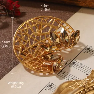 Detailed macro shot of a golden vintage flower brooch with faceted brown crystals