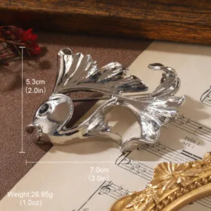 Detailed macro view of a vintage silver goldfish brooch showing dimensions and weight info.