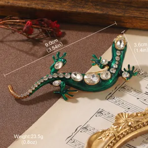 Detailed view of a green enamel lizard brooch with dimensions and weight information