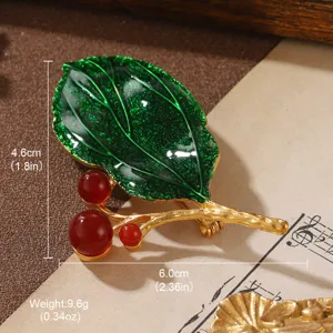 Detail of vintage green leaf brooch with red berries and gold-tone stem measurement