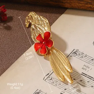 Close-up detail of vintage gold bird brooch with red flower showing dimensions and weight.