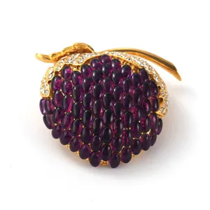 Elegant vintage pomegranate brooch with purple oval stones and gold-toned finish
