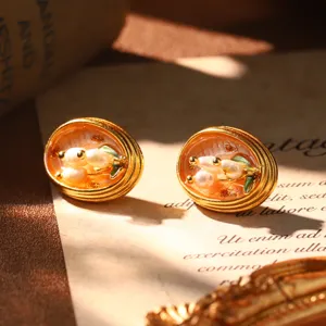 Detailed view of French vintage Monet style enamel earrings with natural pearls