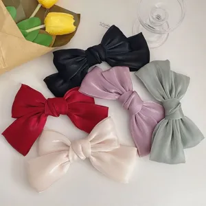 Macro view showing the shimmer texture and multi-color options of elegant bow hair clips