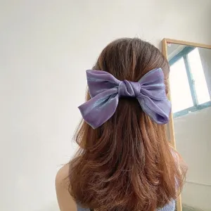Close-up of a shimmering purple bow hair clip in a elegant Korean style