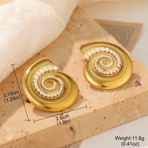 Close-up of golden seashell stud earrings with pearl spiral detail on stone background
