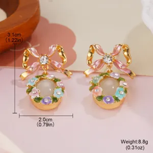 Detailed view of enamel flower earrings with bow and pearl, showing 3.1cm height.