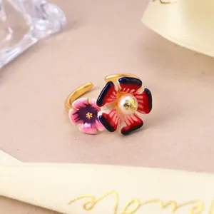 Macro shot of a floral adjustable ring with natural pearl and enamel petals.