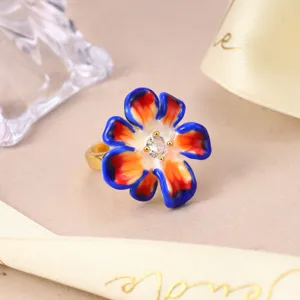Detailed view of colorful enamel flower ring with a central sparkling gemstone