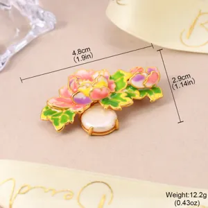 Detailed view of a floral enamel brooch with a pearl, showing 4.8cm size and 12.2g weight