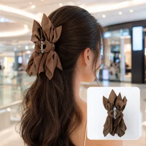 Elegant brown double-sided fabric bow hair claw clip shown on model for back view