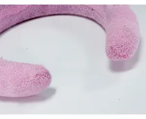 Close-up detail of the soft pink plush texture on the cloud-style sponge headband.