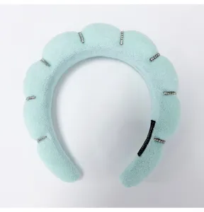 Detailed view of a light blue cloud sponge headband with sparkling rhinestone accents.