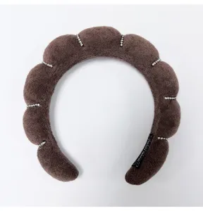 Close-up detail of brown cloud padded headband with elegant sparkling rhinestone accents