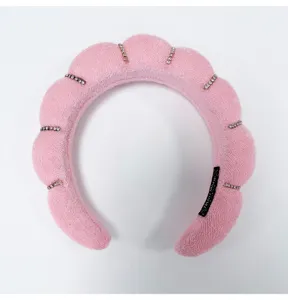 Close-up detail of this pink padded sponge headband with elegant rhinestone accents