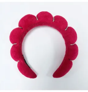 Detail view of pink cloud padded sponge headband with rhinestone accents and soft texture.