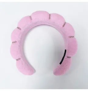 Detailed macro view of a pink puffy cloud headband with sparkling rhinestone accents